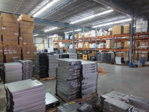 The inside of Keystone Technology Management's facility, filled with stacks of old electronics and big cardboard boxes.